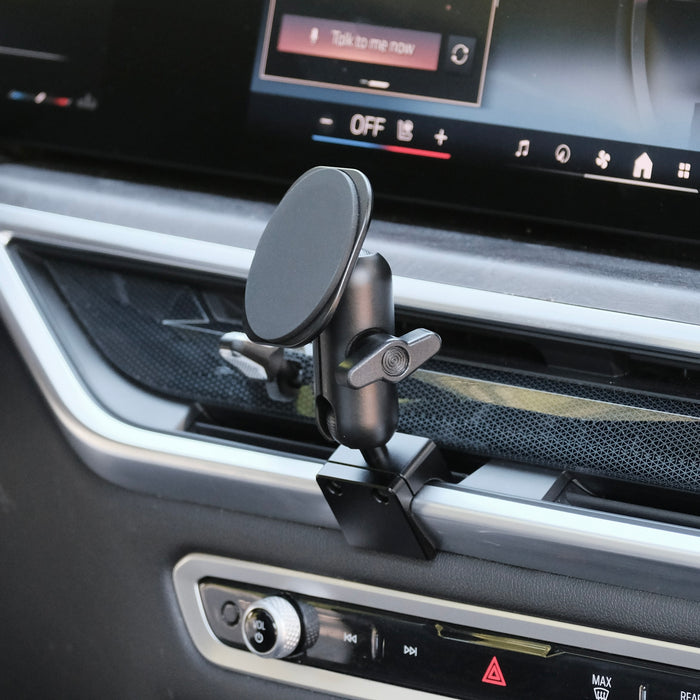 Image of Offroam MagSafe-compatible Phone Mount installed securely in BMW X5 2024-2026 | X6 2024-2027 | X7 2023-2027. This premium phone mount installs easily without drilling or glue. High force magnets hold phone on any trail, road, or track. Perfect placement without blocking screens, driver view, or air flow. Fully adjustable positioning.