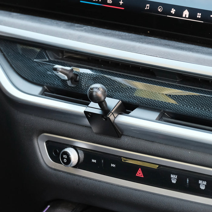 Image of Offroam Mounting Base installed securely in BMW X5 2024-2026 | X6 2024-2027 | X7 2023-2027. This premium all metal phone mounting base installs easily without drilling or glue. Perfect placement without blocking screens, driver view, or air flow.