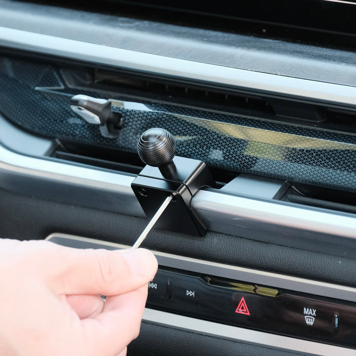 Image of Offroam Phone Mount installation for BMW X5 2024-2026 | X6 2024-2027 | X7 2023-2027. This premium phone mount installs easily without drilling or glue. Spring loaded Universal holder for use with any phone. Perfect placement without blocking screens, driver view, or air flow. Fully adjustable positioning.