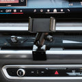 Image of Offroam Phone Mount installed securely in BMW X5 2024-2026 | X6 2024-2027 | X7 2023-2027. This premium phone mount installs easily without drilling or glue. Spring loaded Universal holder for use with any phone. Perfect placement without blocking screens, driver view, or air flow. Fully adjustable positioning.