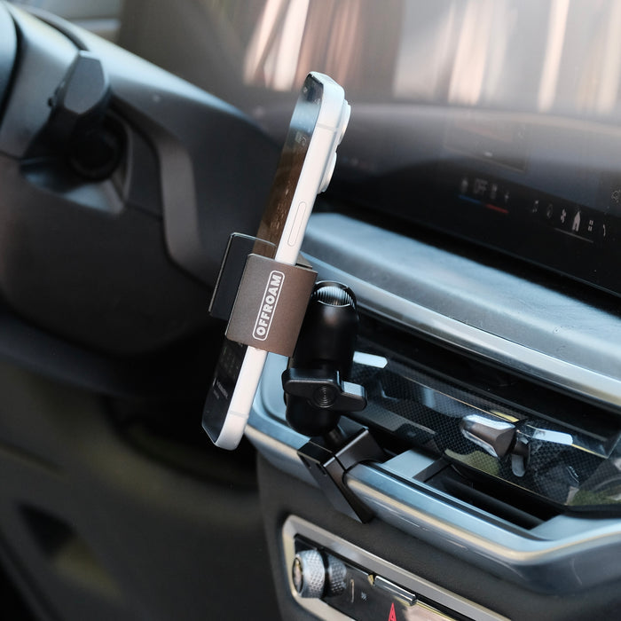 Image of Offroam Phone Mount installed securely in BMW X5 2024-2026 | X6 2024-2027 | X7 2023-2027. This premium phone mount installs easily without drilling or glue. Spring loaded Universal holder for use with any phone. Perfect placement without blocking screens, driver view, or air flow. Fully adjustable positioning.