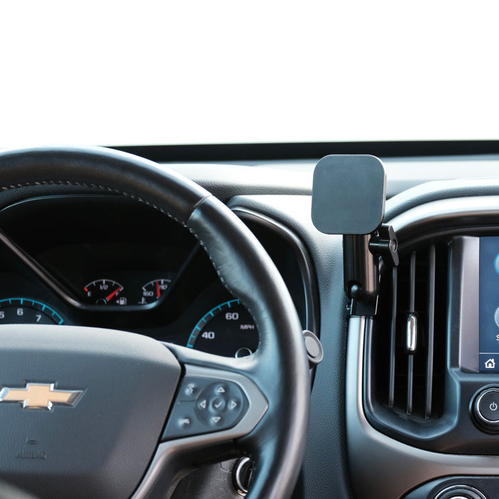 Image of Offroam MagSafe-compatible Phone Mount installed securely in Chevy Colorado | GMC Canyon 2015-2022. This premium phone mount installs easily without drilling or glue. High force magnets hold phone on any trail, road, or track. Perfect placement without blocking screens, driver view, or air flow. Fully adjustable positioning.