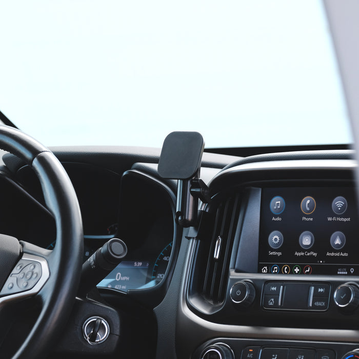 Image of Offroam MagSafe-compatible Phone Mount installed securely in Chevy Colorado | GMC Canyon 2015-2022. This premium phone mount installs easily without drilling or glue. High force magnets hold phone on any trail, road, or track. Perfect placement without blocking screens, driver view, or air flow. Fully adjustable positioning.