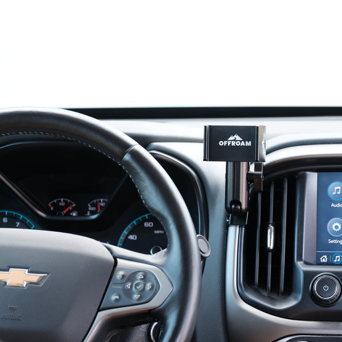Image of Offroam Phone Mount installed securely in Chevy Colorado | GMC Canyon 2015-2022. This premium phone mount installs easily without drilling or glue. Spring loaded Universal holder for use with any phone. Perfect placement without blocking screens, driver view, or air flow. Fully adjustable positioning.