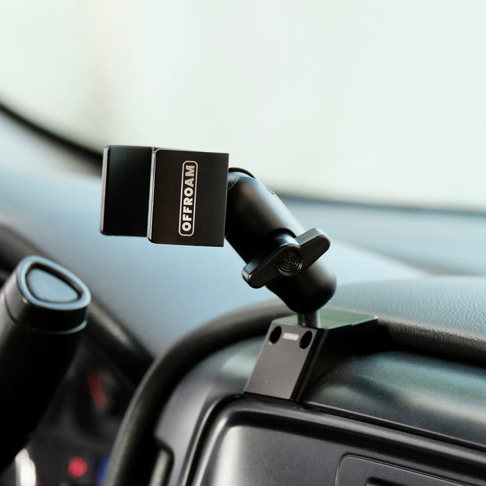 Image of Offroam Phone Mount installed securely in Chevrolet Silverado 1500 2014-2018 | Silverado HD 2500/3500 2015-2019 | Silverado HD 4500/5500/6500 2019-2026 | GMC Sierra 1500 2014-2018 | Sierra HD 2500/3500 2015-2019. This premium phone mount installs easily without drilling or glue. Spring loaded Universal holder for use with any phone. Perfect placement without blocking screens, driver view, or air flow. Fully adjustable positioning.