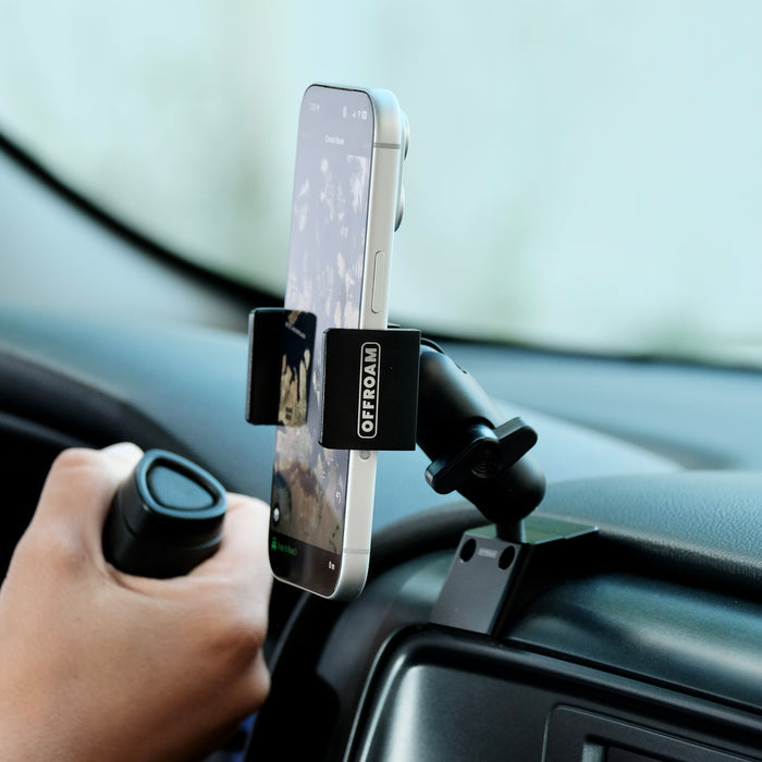 Image of Offroam Phone Mount installed securely in Chevrolet Silverado 1500 2014-2018 | Silverado HD 2500/3500 2015-2019 | Silverado HD 4500/5500/6500 2019-2026 | GMC Sierra 1500 2014-2018 | Sierra HD 2500/3500 2015-2019. This premium phone mount installs easily without drilling or glue. Spring loaded Universal holder for use with any phone. Perfect placement without blocking screens, driver view, or air flow. Fully adjustable positioning.