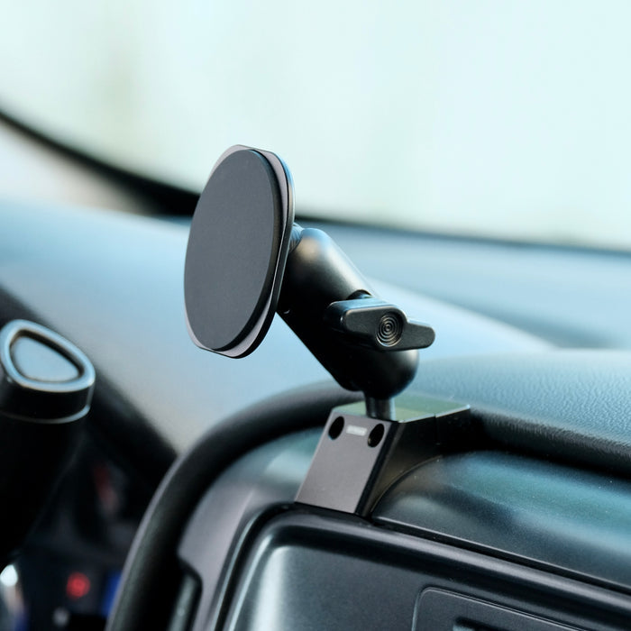 Image of Offroam MagSafe-compatible Phone Mount installed securely in Chevrolet Silverado 1500 2014-2018 | Silverado HD 2500/3500 2015-2019 | Silverado HD 4500/5500/6500 2019-2026 | GMC Sierra 1500 2014-2018 | Sierra HD 2500/3500 2015-2019. This premium phone mount installs easily without drilling or glue. High force magnets hold phone on any trail, road, or track. Perfect placement without blocking screens, driver view, or air flow. Fully adjustable positioning.