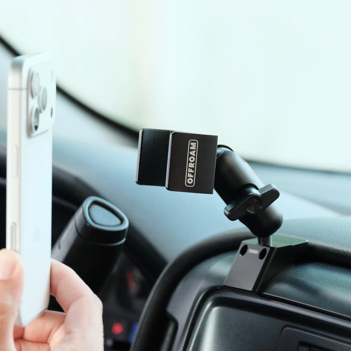 Image of Offroam Phone Mount installed securely in Chevrolet Silverado 1500 2014-2018 | Silverado HD 2500/3500 2015-2019 | Silverado HD 4500/5500/6500 2019-2026 | GMC Sierra 1500 2014-2018 | Sierra HD 2500/3500 2015-2019. This premium phone mount installs easily without drilling or glue. Spring loaded Universal holder for use with any phone. Perfect placement without blocking screens, driver view, or air flow. Fully adjustable positioning.