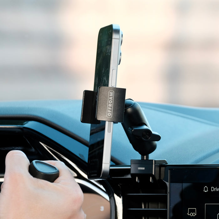 Image of Offroam Phone Mount installed securely in Chevrolet Silverado 2022-2026 | Silverado HD 2024-2026 and GMC Sierra 1500 2022-2026 | Sierra HD 2024-2026 with 13.4-in. display. This premium phone mount installs easily without drilling or glue. Spring loaded Universal holder for use with any phone. Perfect placement without blocking screens, driver view, or air flow. Fully adjustable positioning.