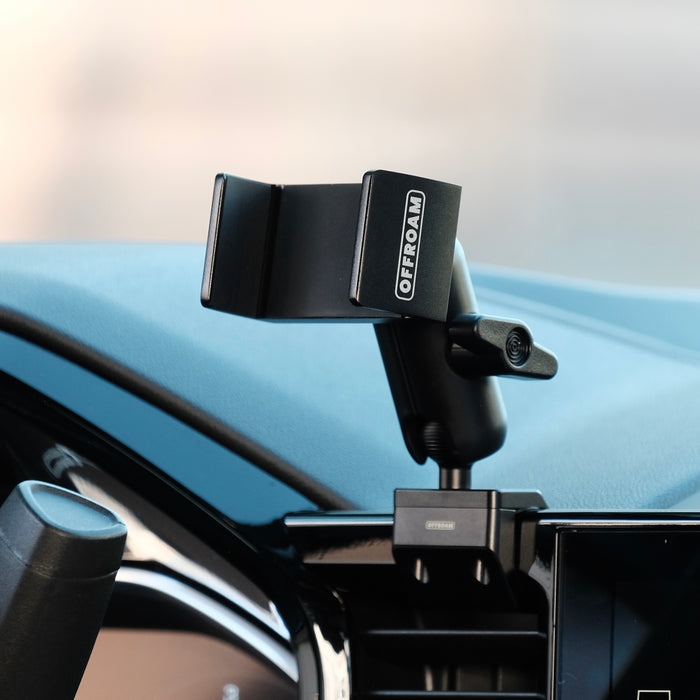 Image of Offroam Phone Mount installed securely in Chevrolet Silverado 2022-2026 | Silverado HD 2024-2026 and GMC Sierra 1500 2022-2026 | Sierra HD 2024-2026 with 13.4-in. display. This premium phone mount installs easily without drilling or glue. Spring loaded Universal holder for use with any phone. Perfect placement without blocking screens, driver view, or air flow. Fully adjustable positioning.