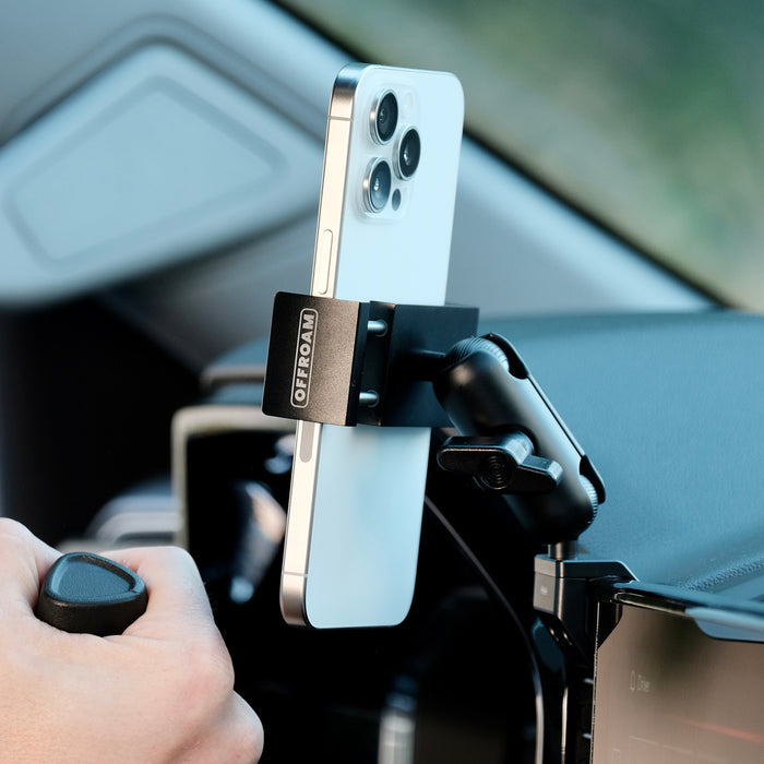 Image of Offroam Phone Mount installed securely in Chevrolet Silverado 2022-2026 | Silverado HD 2024-2026 and GMC Sierra 1500 2022-2026 | Sierra HD 2024-2026 with 13.4-in. display. This premium phone mount installs easily without drilling or glue. Spring loaded Universal holder for use with any phone. Perfect placement without blocking screens, driver view, or air flow. Fully adjustable positioning.