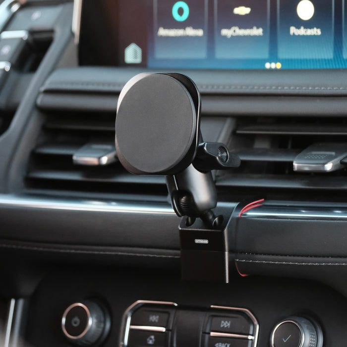 Image of Offroam MagSafe-compatible Phone Mount installed securely in Chevrolet Suburban | Tahoe & GMC Yukon | Yukon XL 2021-2024. This premium phone mount installs easily without drilling or glue. High force magnets hold phone on any trail, road, or track. Perfect placement without blocking screens, driver view, or air flow. Fully adjustable positioning.