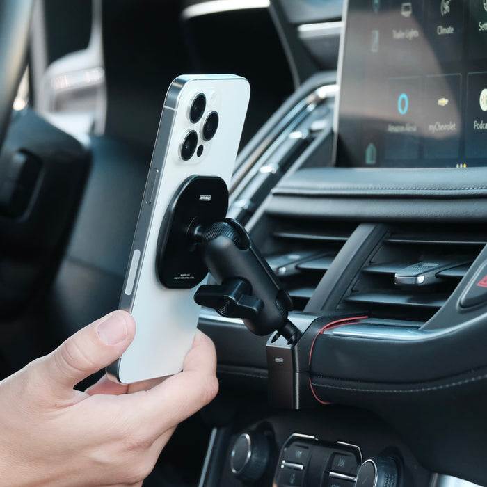 Image of Offroam MagSafe-compatible Phone Mount installed securely in Chevrolet Suburban | Tahoe & GMC Yukon | Yukon XL 2021-2024. This premium phone mount installs easily without drilling or glue. High force magnets hold phone on any trail, road, or track. Perfect placement without blocking screens, driver view, or air flow. Fully adjustable positioning.