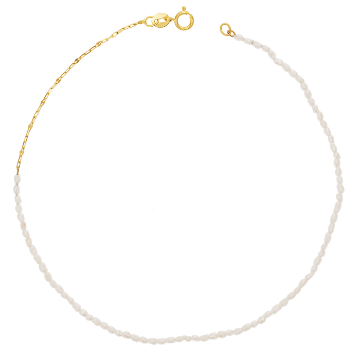 A dainty freshwater pearl anklet with 14k solid yellow gold chain and clasp.