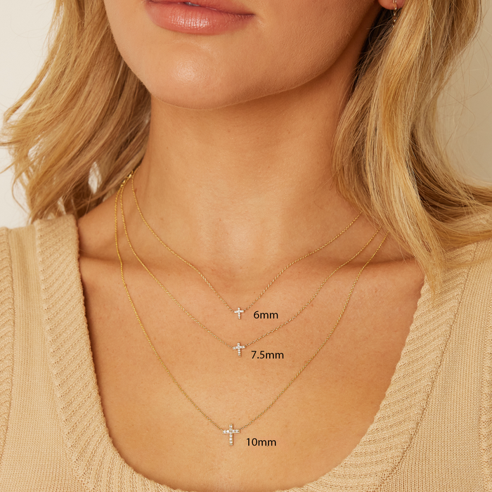 Model with three diamond pave cross necklaces on and three different 14K solid gold chain lengths.