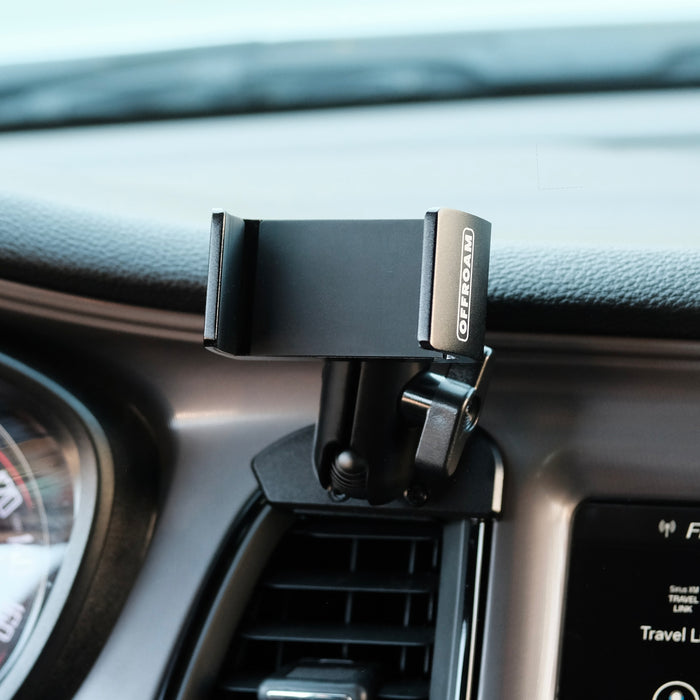 Image of Offroam Phone Mount installed securely in Dodge Challenger 2015-2023. This premium phone mount installs easily without drilling or glue. Spring loaded Universal holder for use with any phone. Perfect placement without blocking screens, driver view, or air flow. Fully adjustable positioning.