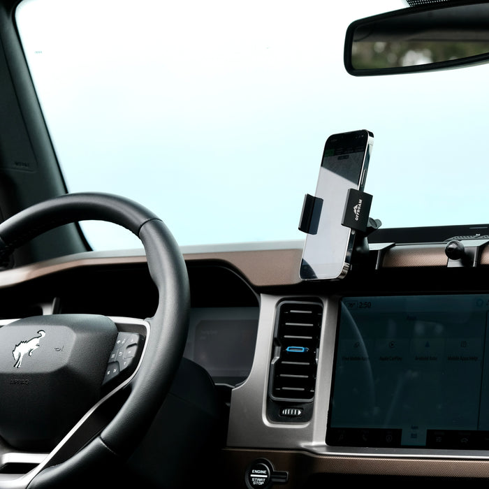 Image of Offroam Phone Mount installed securely in Ford Bronco 2021-2025. This premium phone mount installs easily without drilling or glue. Spring loaded Universal holder for use with any phone. Perfect placement without blocking screens, driver view, or air flow. Fully adjustable positioning.