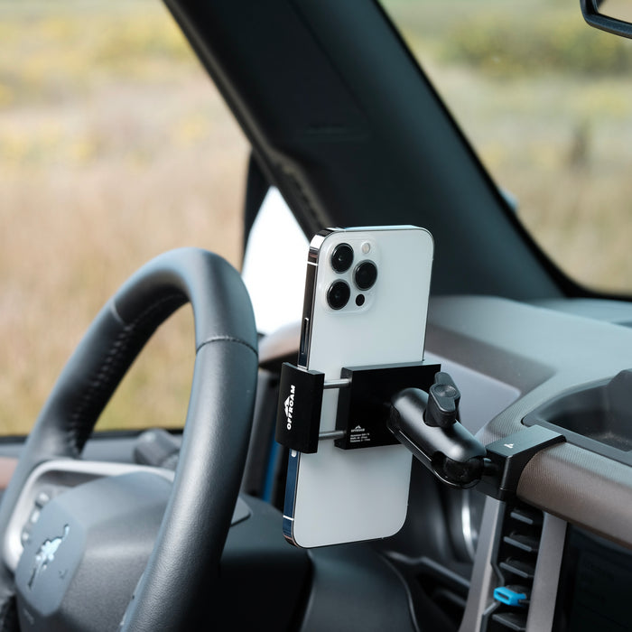Image of Offroam Phone Mount installed securely in Ford Bronco 2021-2025. This premium phone mount installs easily without drilling or glue. Spring loaded Universal holder for use with any phone. Perfect placement without blocking screens, driver view, or air flow. Fully adjustable positioning.