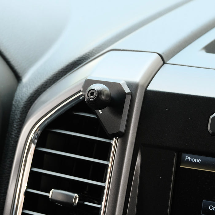 Image of Offroam Mounting Base installed securely in Ford F-150 2015-2020 | Super Duty 2017-2021 & 2022 (XL and XLT) | Expedition 2018-2021. This premium all metal phone mounting base installs easily without drilling or glue. Perfect placement without blocking screens, driver view, or air flow.