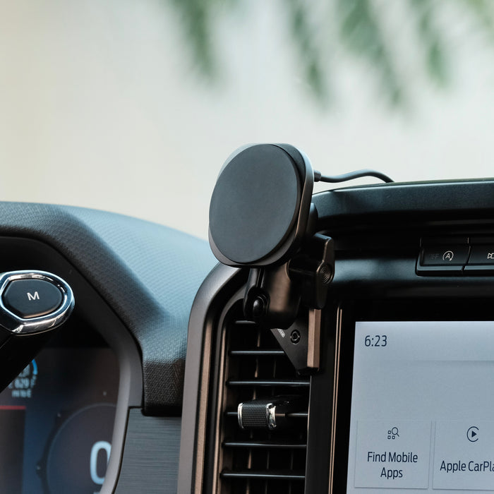 Image of Offroam MagSafe-compatible Phone Mount installed securely in Ford F-150 2021-2026 | F-250/F-350 2023-2026 | F-150 Lightning (XL & PRO) 2022-2026. This premium phone mount installs easily without drilling or glue. High force magnets hold phone on any trail, road, or track. Perfect placement without blocking screens, driver view, or air flow. Fully adjustable positioning.