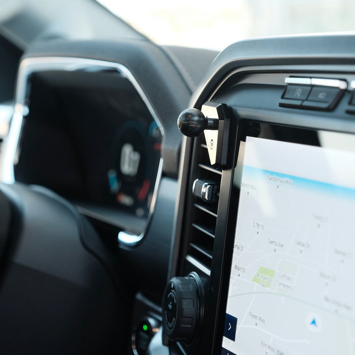 Image of Offroam Mounting Base installed securely in Ford F-150 2021-2026 | F-250/F-350 2023-2026 | F-150 Lightning (XL & PRO) 2022-2026. This premium all metal phone mounting base installs easily without drilling or glue. Perfect placement without blocking screens, driver view, or air flow.