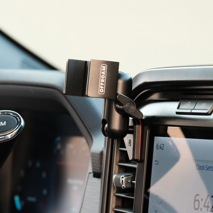 Image of Offroam Phone Mount installed securely in Ford F-150 2021-2026 | F-250/F-350 2023-2026 | F-150 Lightning (XL & PRO) 2022-2026. This premium phone mount installs easily without drilling or glue. Spring loaded Universal holder for use with any phone. Perfect placement without blocking screens, driver view, or air flow. Fully adjustable positioning.