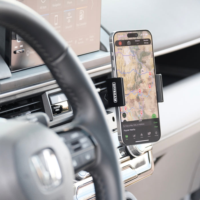 Image of Offroam Phone Mount installed securely in Honda Pilot 2023-2026 | Passport 2026. This premium phone mount installs easily without drilling or glue. Spring loaded Universal holder for use with any phone. Perfect placement without blocking screens, driver view, or air flow. Fully adjustable positioning.