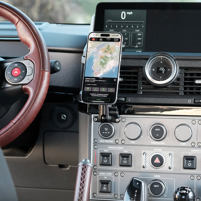 Image of Offroam MagSafe-compatible Phone Mount installed securely in INEOS Grenadier 2022-2026. This premium phone mount installs easily without drilling or glue. High force magnets hold phone on any trail, road, or track. Perfect placement without blocking screens, driver view, or air flow. Fully adjustable positioning.