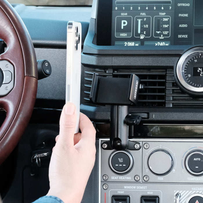 Image of Offroam Phone Mount installed securely in INEOS Grenadier 2022-2026. This premium phone mount installs easily without drilling or glue. Spring loaded Universal holder for use with any phone. Perfect placement without blocking screens, driver view, or air flow. Fully adjustable positioning.