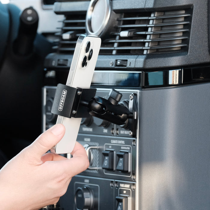 Image of Offroam Phone Mount installed securely in INEOS Grenadier 2022-2026. This premium phone mount installs easily without drilling or glue. Spring loaded Universal holder for use with any phone. Perfect placement without blocking screens, driver view, or air flow. Fully adjustable positioning.