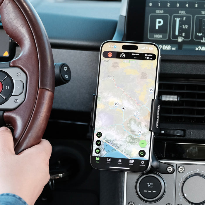 Image of Offroam Phone Mount installed securely in INEOS Grenadier 2022-2026. This premium phone mount installs easily without drilling or glue. Spring loaded Universal holder for use with any phone. Perfect placement without blocking screens, driver view, or air flow. Fully adjustable positioning.