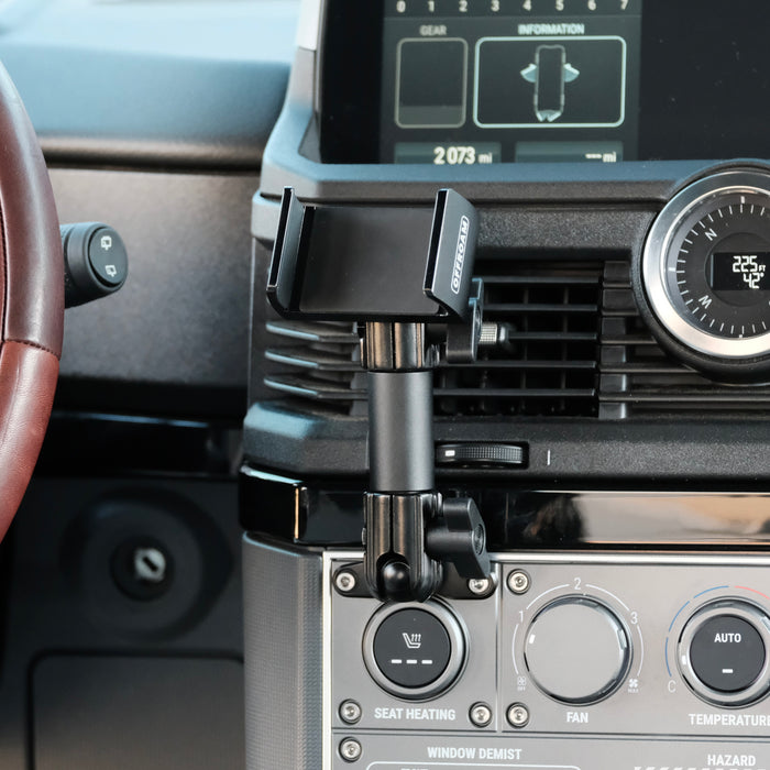 Image of Offroam Phone Mount installed securely in INEOS Grenadier 2022-2026. This premium phone mount installs easily without drilling or glue. Spring loaded Universal holder for use with any phone. Perfect placement without blocking screens, driver view, or air flow. Fully adjustable positioning.