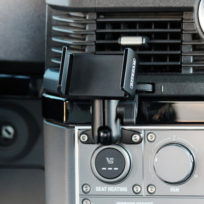 Image of Offroam Phone Mount installed securely in INEOS Grenadier 2022-2026. This premium phone mount installs easily without drilling or glue. Spring loaded Universal holder for use with any phone. Perfect placement without blocking screens, driver view, or air flow. Fully adjustable positioning.