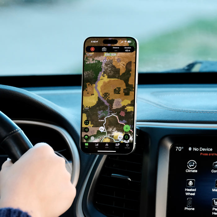 Image of Offroam MagSafe-compatible Phone Mount installed securely in Jeep Cherokee 2014-2018. This premium phone mount installs easily without drilling or glue. High force magnets hold phone on any trail, road, or track. Perfect placement without blocking screens, driver view, or air flow. Fully adjustable positioning.