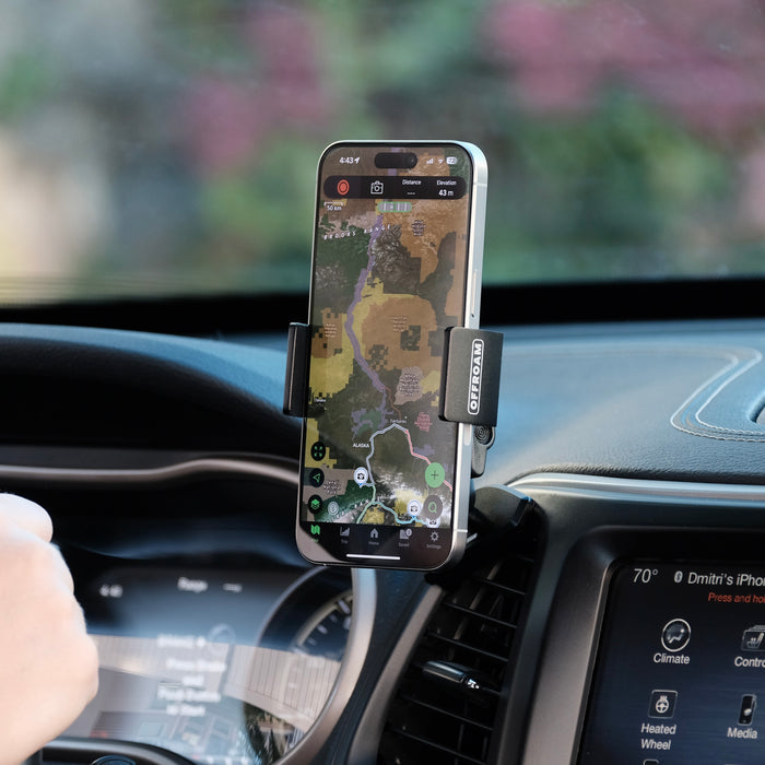 Image of Offroam Phone Mount installed securely in Jeep Cherokee 2014-2018. This premium phone mount installs easily without drilling or glue. Spring loaded Universal holder for use with any phone. Perfect placement without blocking screens, driver view, or air flow. Fully adjustable positioning.