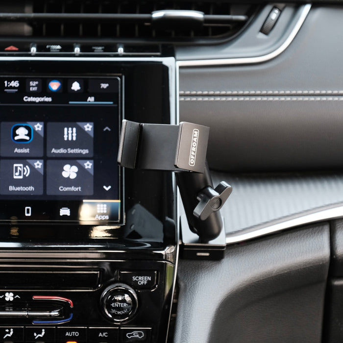 Image of Offroam Phone Mount installed securely on passenger side in Jeep Grand Cherokee 2022-2026. This premium phone mount installs easily without drilling or glue. Spring loaded Universal holder for use with any phone. Perfect placement without blocking screens, driver view, or air flow. Fully adjustable positioning.