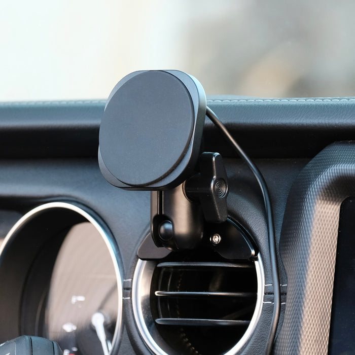 Image of Offroam MagSafe-compatible Phone Mount installed securely in Jeep Wrangler 2018-2023 | Gladiator 2019-2023. This premium phone mount installs easily without drilling or glue. High force magnets hold phone on any trail, road, or track. Perfect placement without blocking screens, driver view, or air flow. Fully adjustable positioning.
