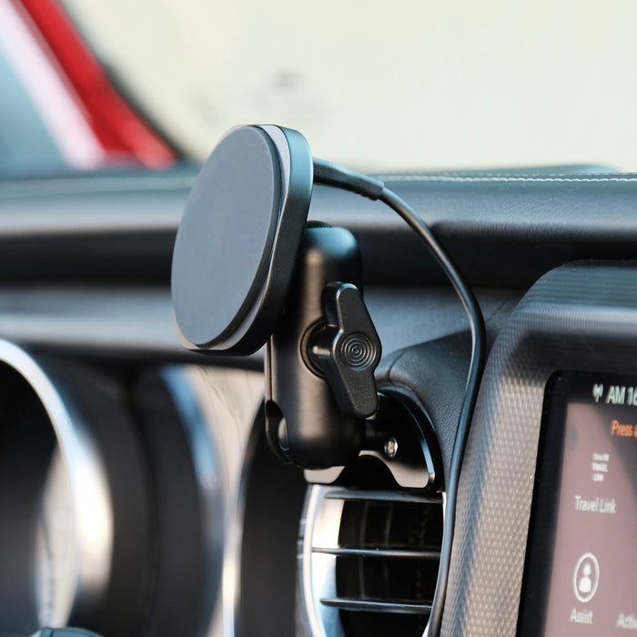 Image of Offroam MagSafe-compatible Phone Mount installed securely in Jeep Wrangler 2018-2023 | Gladiator 2019-2023. This premium phone mount installs easily without drilling or glue. High force magnets hold phone on any trail, road, or track. Perfect placement without blocking screens, driver view, or air flow. Fully adjustable positioning.