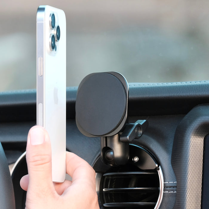 Image of Offroam MagSafe-compatible Phone Mount installed securely in Jeep Wrangler 2018-2023 | Gladiator 2019-2023. This premium phone mount installs easily without drilling or glue. High force magnets hold phone on any trail, road, or track. Perfect placement without blocking screens, driver view, or air flow. Fully adjustable positioning.