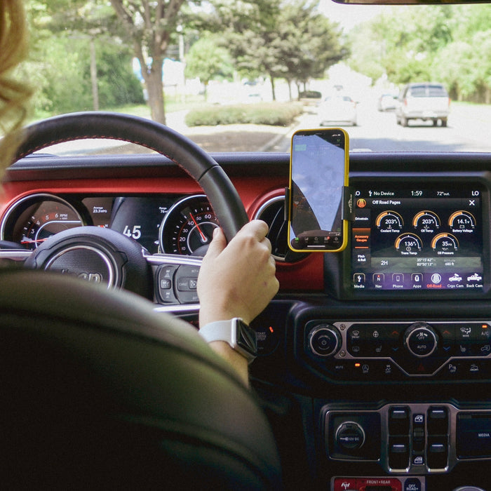 Image of Offroam Phone Mount installed securely in Jeep Wrangler 2018-2023 | Gladiator 2019-2023. This premium phone mount installs easily without drilling or glue. Spring loaded Universal holder for use with any phone. Perfect placement without blocking screens, driver view, or air flow. Fully adjustable positioning.