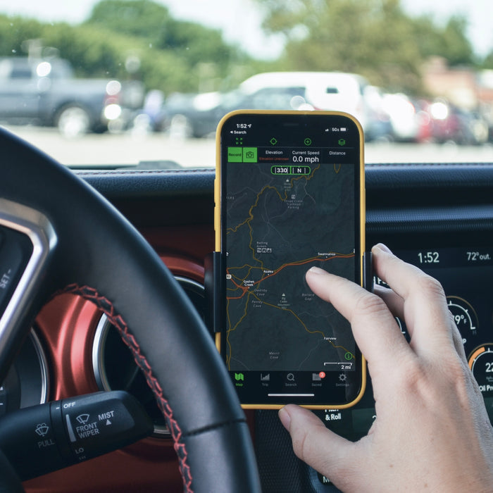 Image of Offroam Phone Mount installed securely in Jeep Wrangler 2018-2023 | Gladiator 2019-2023. This premium phone mount installs easily without drilling or glue. Spring loaded Universal holder for use with any phone. Perfect placement without blocking screens, driver view, or air flow. Fully adjustable positioning.