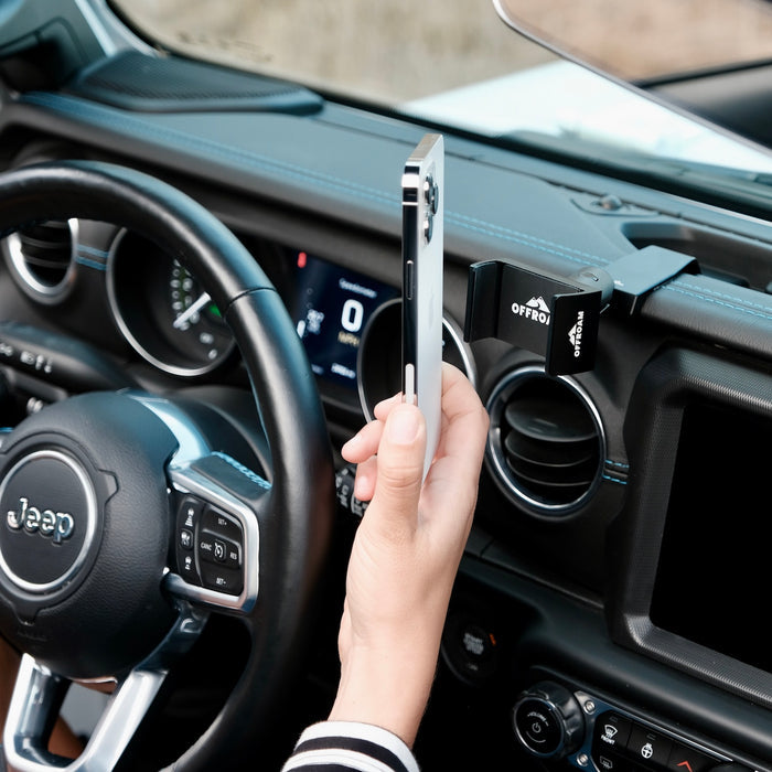 Image of Offroam Phone Mount installed securely in Jeep Wrangler 2018-2023 | Gladiator 2019-2023. This premium phone mount installs easily without drilling or glue. Spring loaded Universal holder for use with any phone. Perfect placement without blocking screens, driver view, or air flow. Fully adjustable positioning.