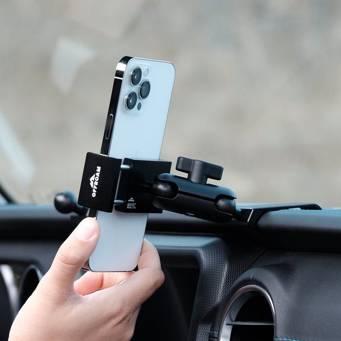 Image of Offroam Phone Mount installed securely in Jeep Wrangler 2018-2023 | Gladiator 2019-2023. This premium phone mount installs easily without drilling or glue. Spring loaded Universal holder for use with any phone. Perfect placement without blocking screens, driver view, or air flow. Fully adjustable positioning.