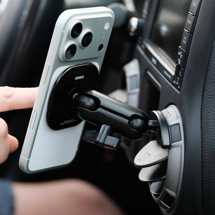 Offroam non-charging MagSafe compatible mount shown installed in Jeep Wrangler JK 2011-2018 air vent bezel without blocking air flow while holding iPhone with MagSafe securely on off-road trails