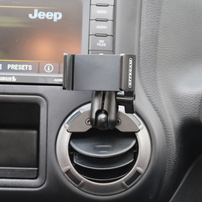 Image of Offroam Phone Mount installed securely in Jeep Wrangler JK 2011-2018. This premium phone mount installs easily without drilling or glue. Spring loaded Universal holder for use with any phone. Perfect placement without blocking screens, driver view, or air flow. Fully adjustable positioning.