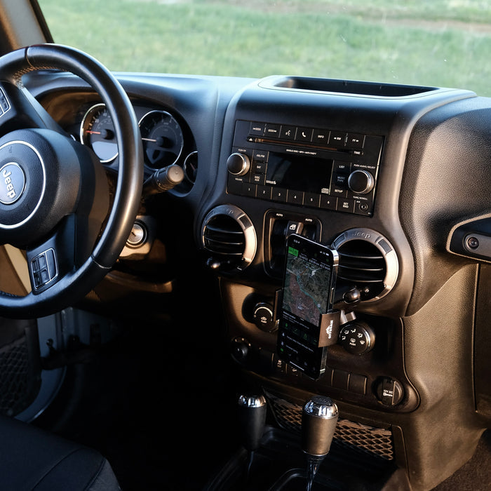 Image of Offroam Phone Mount installed securely in Jeep Wrangler JK 2011-2018. This premium phone mount installs easily without drilling or glue. Spring loaded Universal holder for use with any phone. Perfect placement without blocking screens, driver view, or air flow. Fully adjustable positioning.