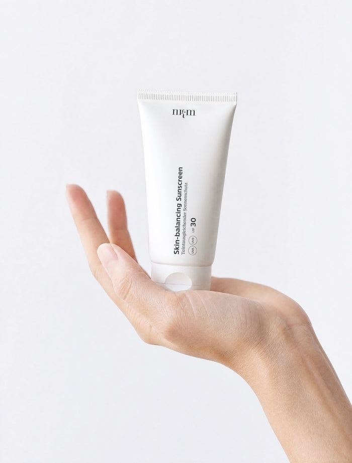 Hand hält Skin-balancing Sunscreen