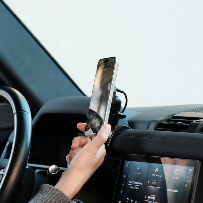 Image of Offroam MagSafe-compatible Phone Mount installed securely in Land Rover Defender 2020-2026. This premium phone mount installs easily without drilling or glue. High force magnets hold phone on any trail, road, or track. Perfect placement without blocking screens, driver view, or air flow. Fully adjustable positioning.