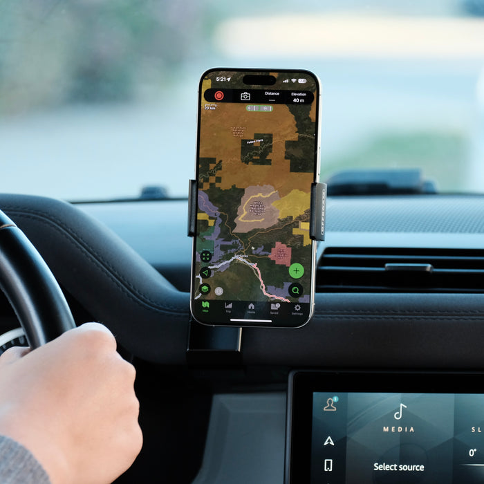 Image of Offroam Phone Mount installed securely in Land Rover Defender 2020-2026. This premium phone mount installs easily without drilling or glue. Spring loaded Universal holder for use with any phone. Perfect placement without blocking screens, driver view, or air flow. Fully adjustable positioning.