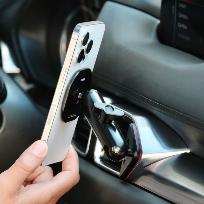Image of Offroam MagSafe-compatible Phone Mount installed securely in Mazda CX-5 2017-2025. This premium phone mount installs easily without drilling or glue. High force magnets hold phone on any trail, road, or track. Perfect placement without blocking screens, driver view, or air flow. Fully adjustable positioning.
